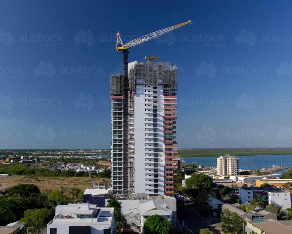 A large apartment block in the process of being built near a harbor - Australian Stock Image