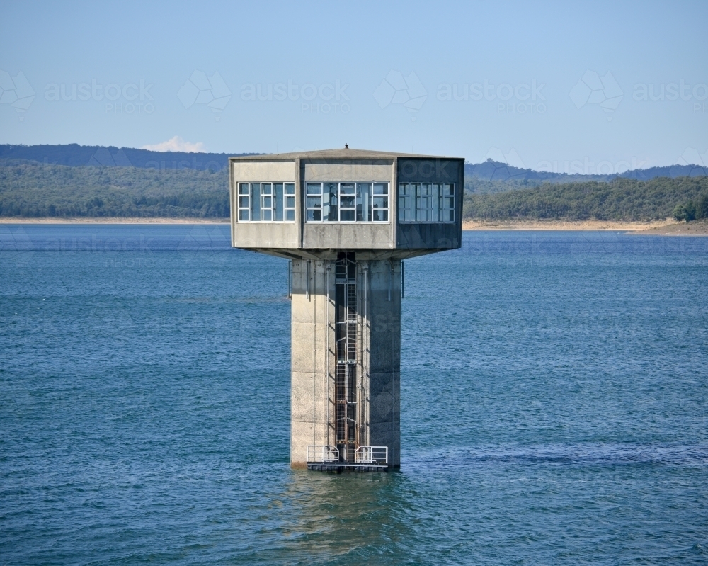 Image of A large control tower in a freshwater reservoir - Austockphoto