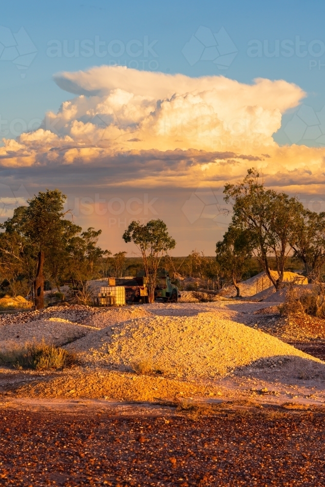 A large thunderstorm over an outback mining landscape at sunset - Australian Stock Image