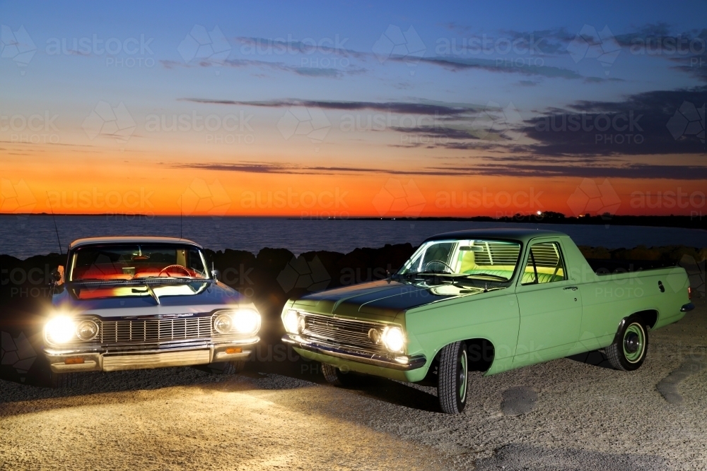 A light-painting of vintage 1967 Holden HR ute and 1964 Chevrolet Impala at dusk. - Australian Stock Image