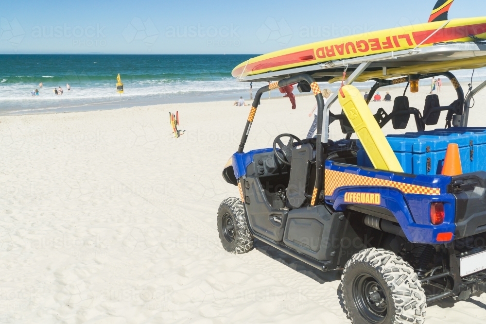 A live saver's beach buggy, loaded up and ready on a white sandy beach - Australian Stock Image