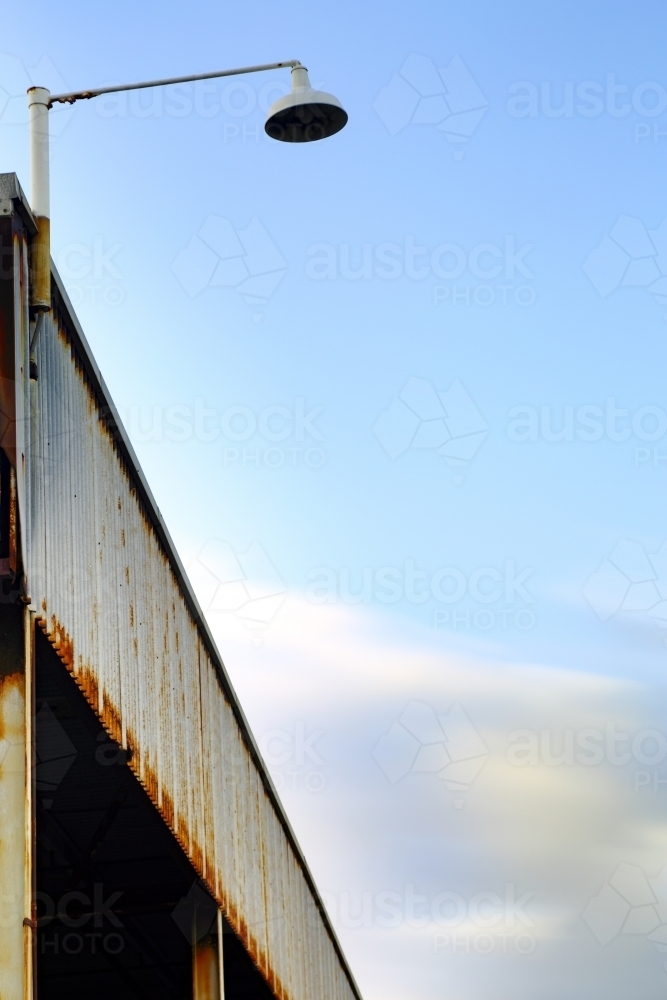 A long exposure of an industrial building as weather approaches - Australian Stock Image