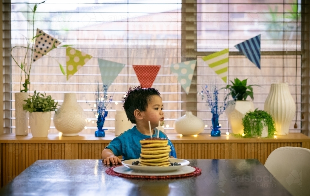 A lucky kid getting a hotcake stack on his second birthday - Australian Stock Image