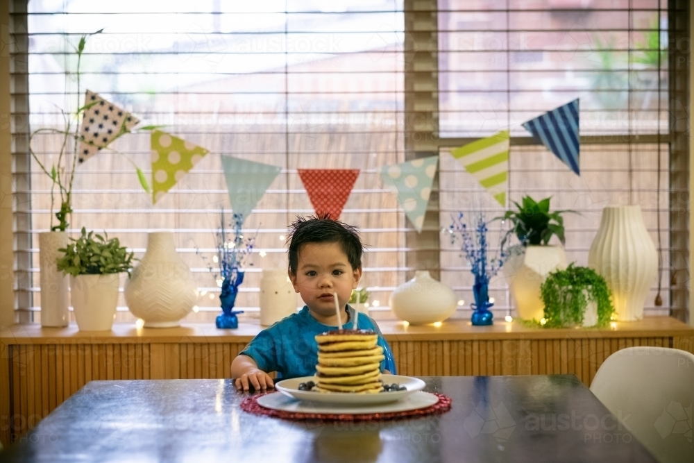 A lucky kid getting a hotcake stack on his second birthday - Australian Stock Image