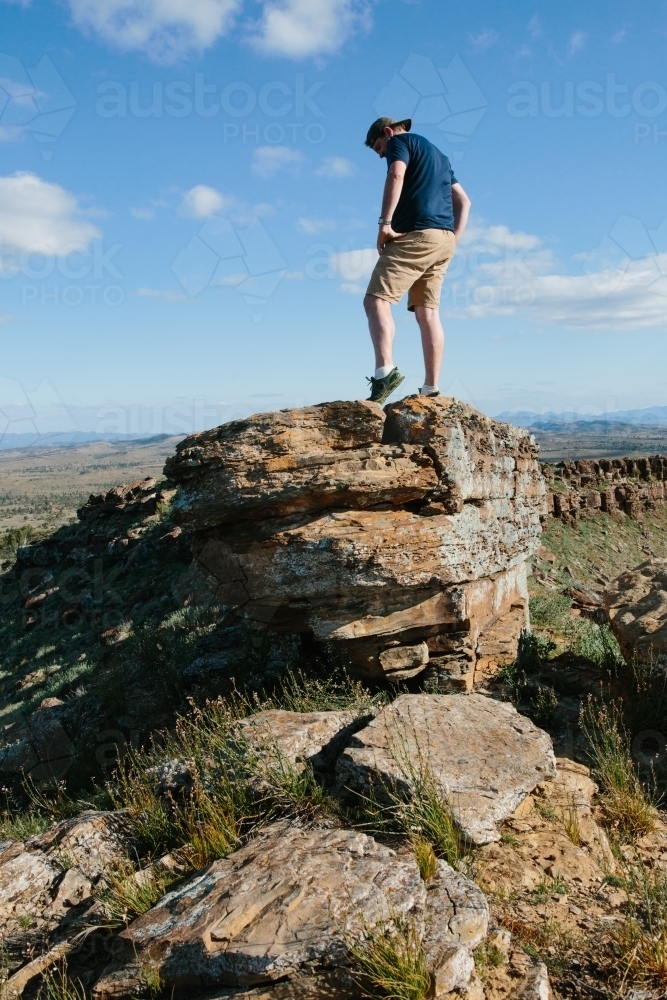 A man in hiking gear overlooking the rugged landscape of the Flinders Ranges - Australian Stock Image