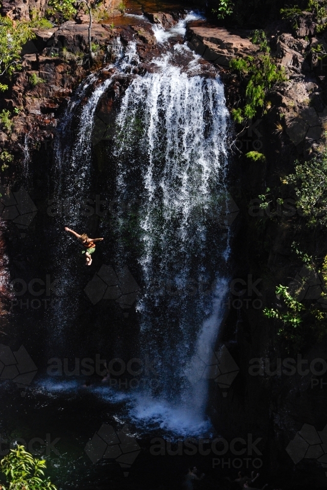 A man in mid air after jumping off a very high waterfall - Australian Stock Image