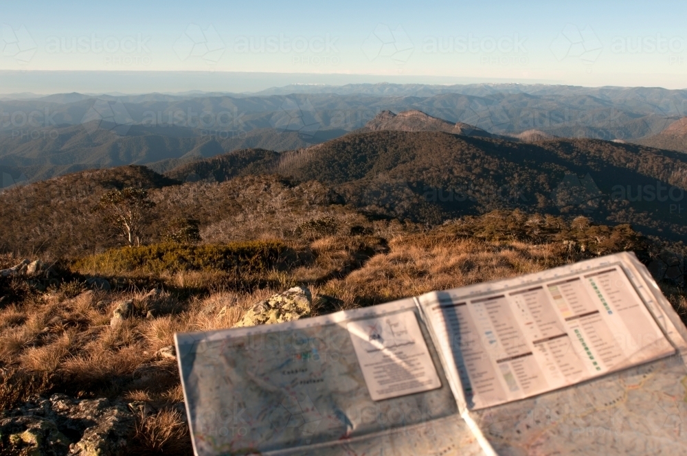 A map being held with mountain ranges in the background. - Australian Stock Image