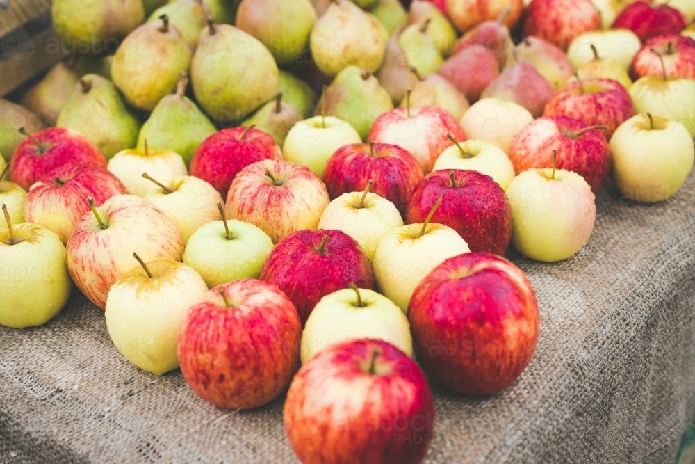 A market stall with red and yellow apples and green pears - Australian Stock Image