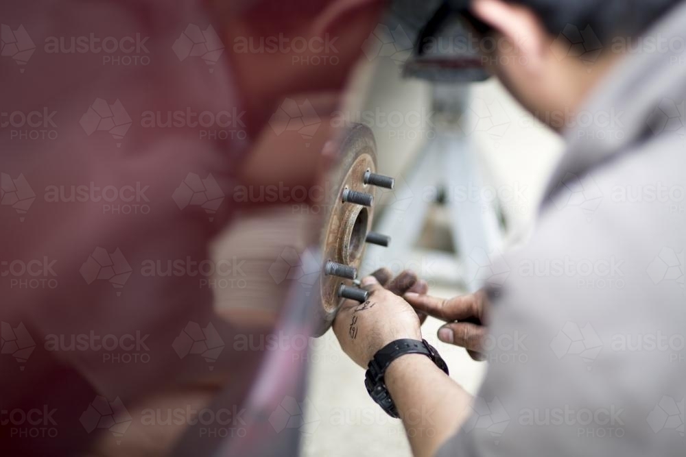 A mechanic services a brake hub. - Australian Stock Image