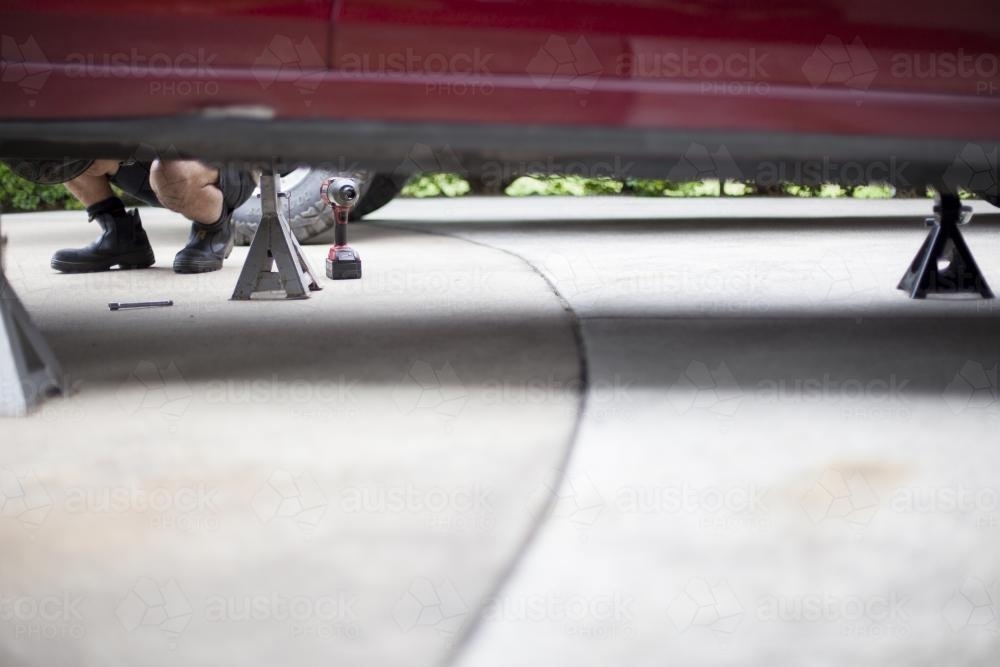 A mechanic services a vehicle. - Australian Stock Image