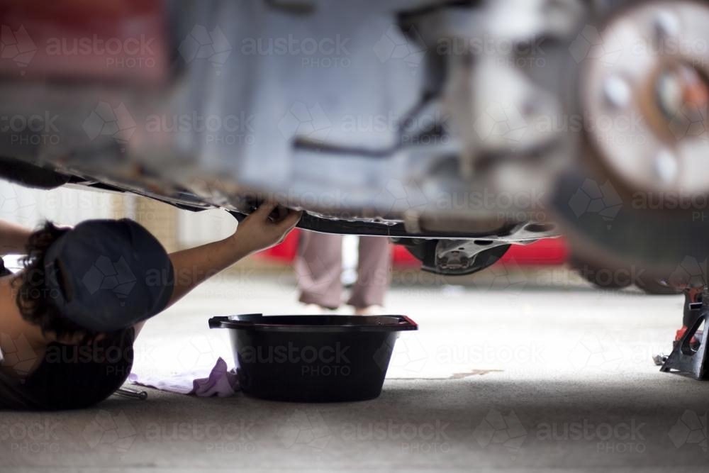 A mechanic services a vehicle. - Australian Stock Image