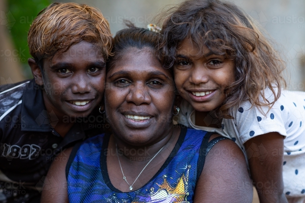 a mother with her two young children posing for a photo - Australian Stock Image