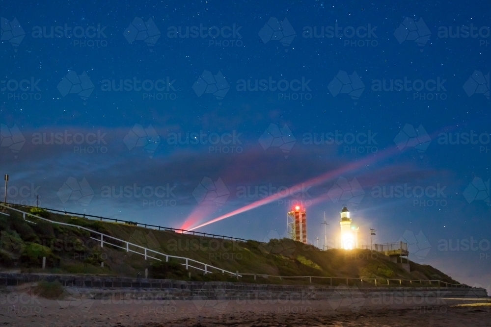 Image of A night time view of a Lighthouse and Navigational lights and