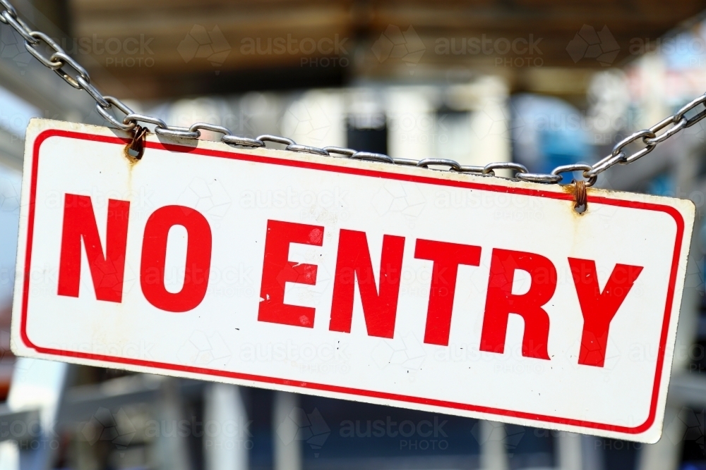 A NO ENTRY sign dangles from a chain - Australian Stock Image