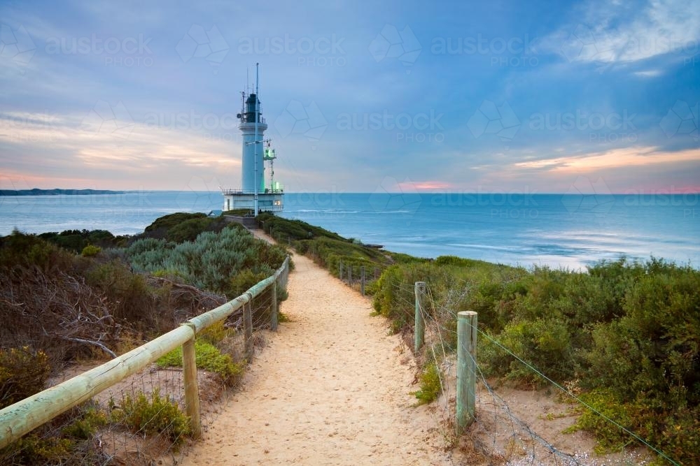 Image of A path leading to a lighthouse - Austockphoto
