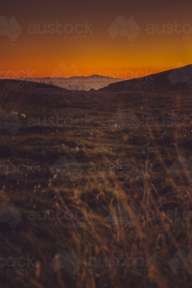 A Peaceful Field with the You Yangs in the Distance at Sunrise - Australian Stock Image