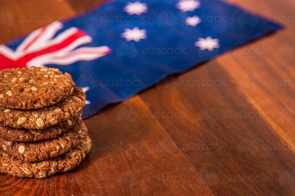 A pile of ANZAC biscuits next to the Australian flag - Australian Stock Image