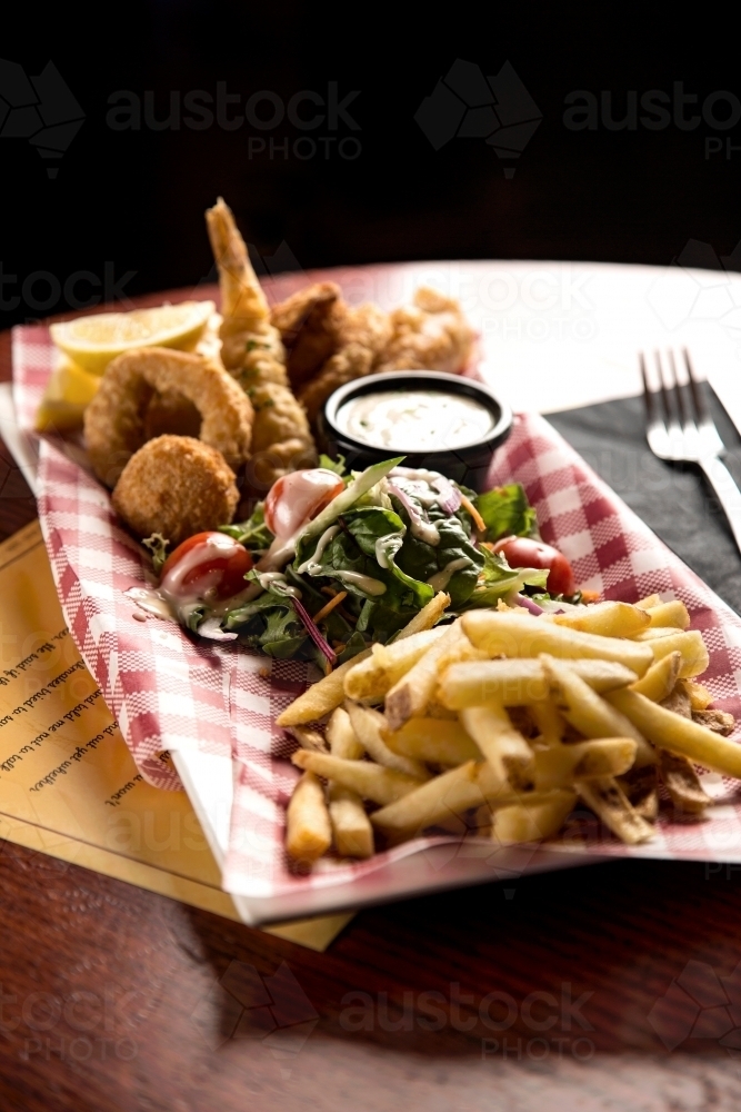 A plate of fried seafood, salad and chips - Australian Stock Image