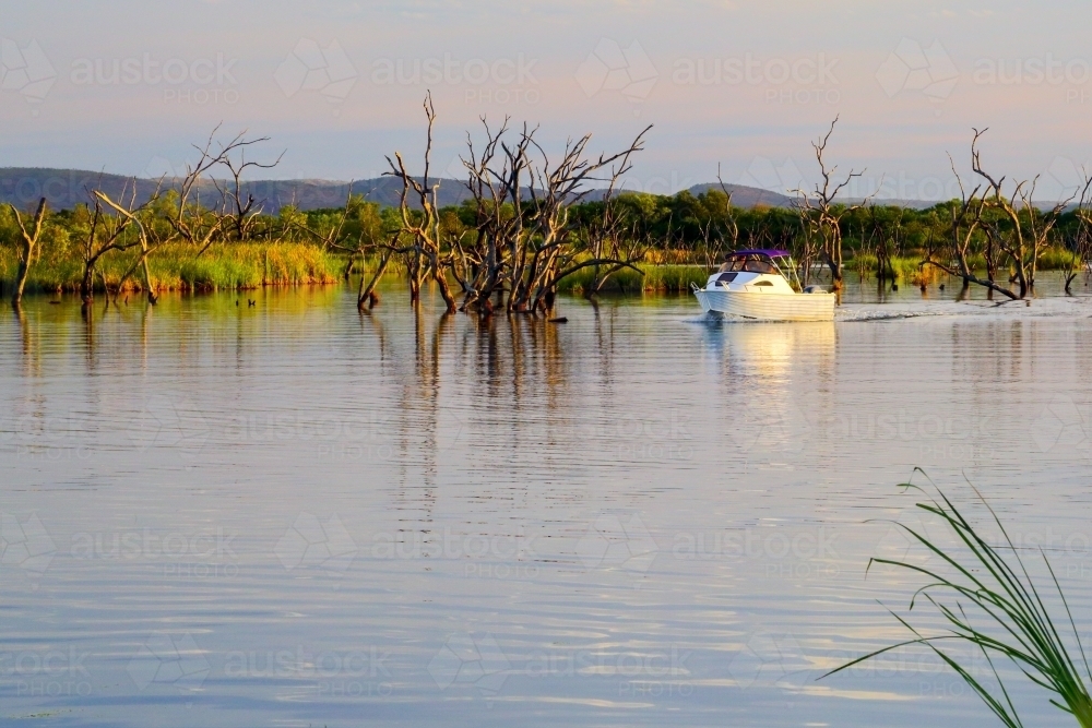 A powerboat on Lily Creek Lagoon. - Australian Stock Image
