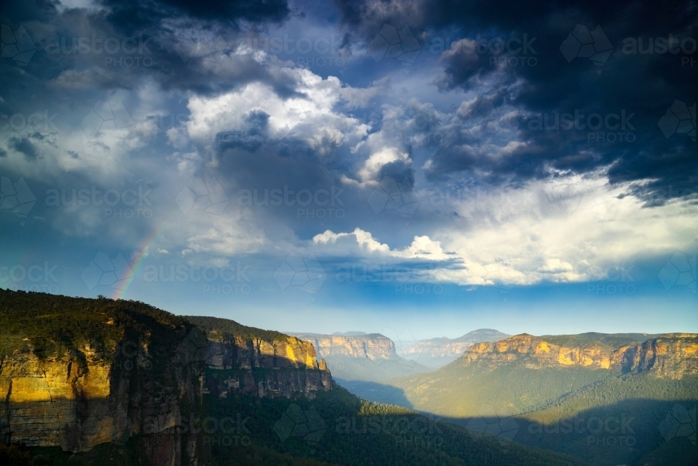 A rainbow over the Grose Valley in the Blue Mountains National Park - Australian Stock Image