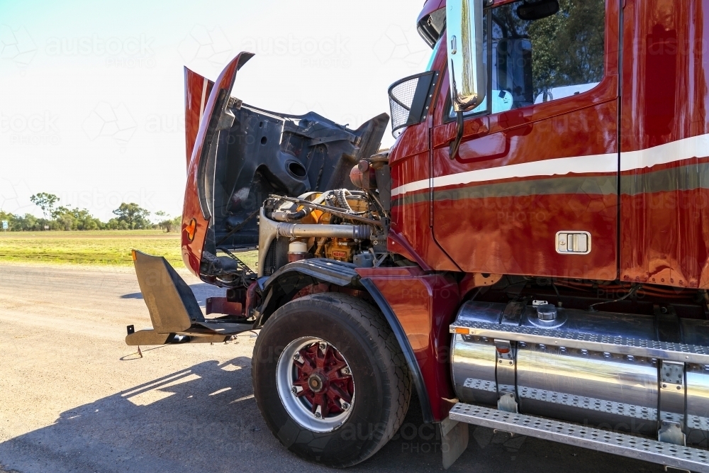 A red or maroon semi-trailer broken down with bonnet up. - Australian Stock Image