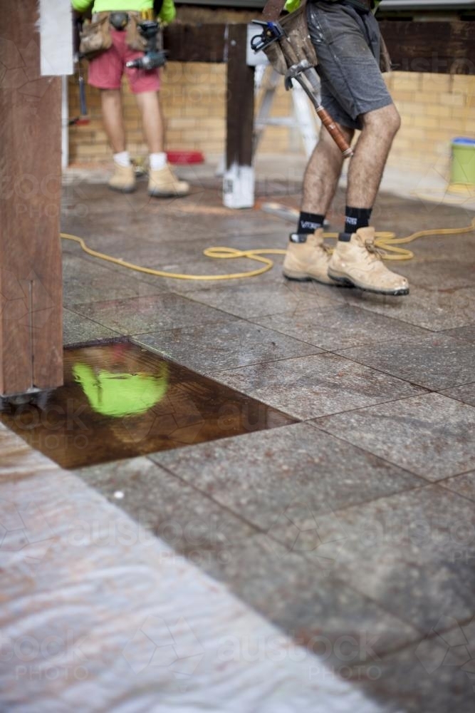 A reflection of a tradesman working on home renovations. - Australian Stock Image