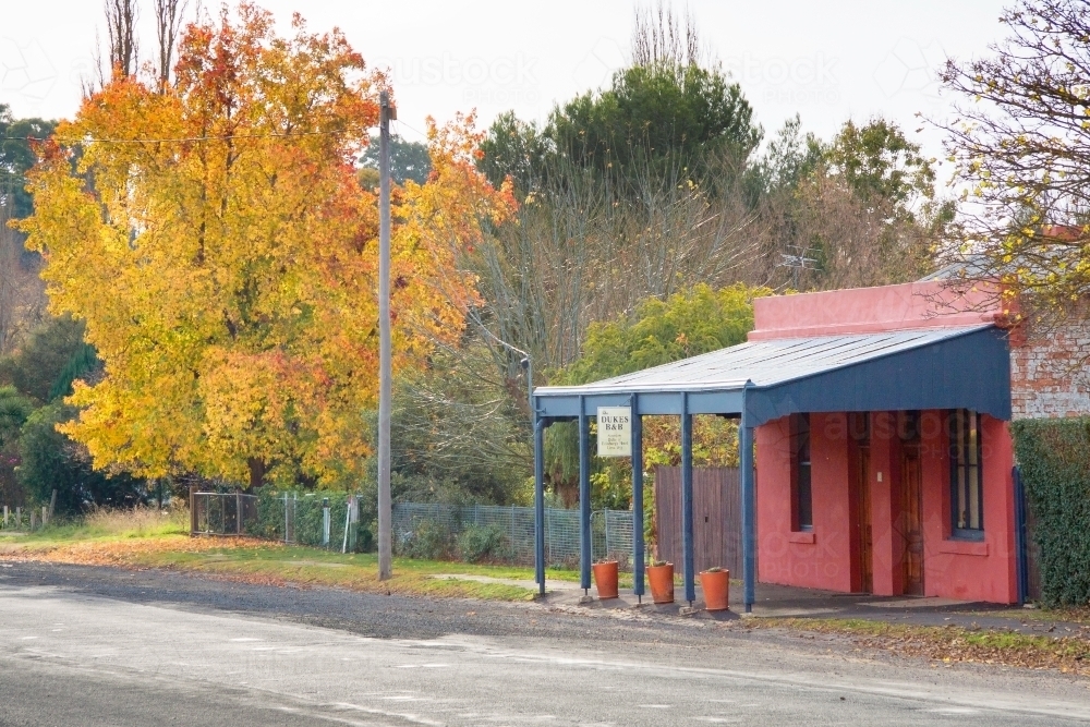 A restored miners cottage and verandah in an Autumn street - Australian Stock Image