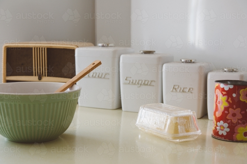 A retro style kitchen scene with radio, mixing bowl, canisters, butter dish and sifter - Australian Stock Image