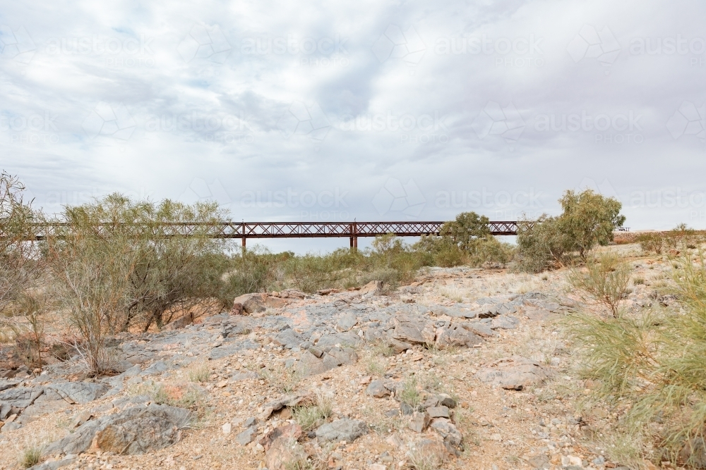 A rocky terrain with a bridge made of metal - Australian Stock Image