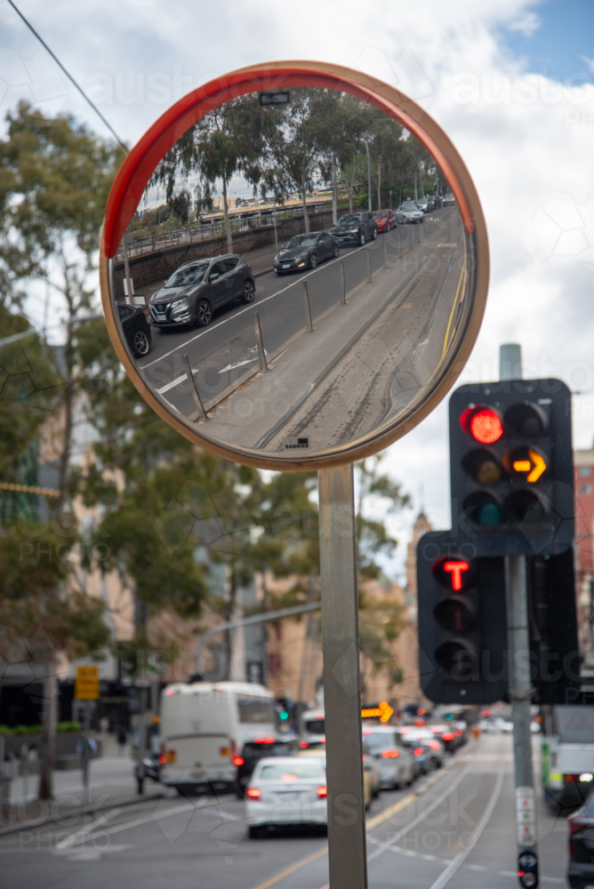 A round safety mirror for traffic and trams with a reflection - Australian Stock Image