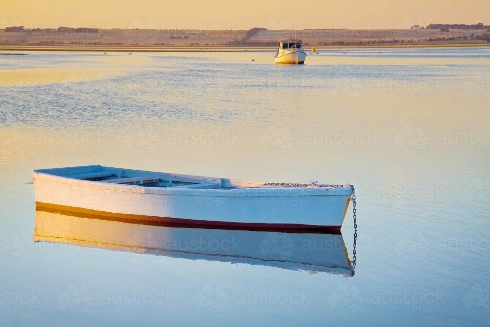 A row boat anchored in a calm bay - Australian Stock Image