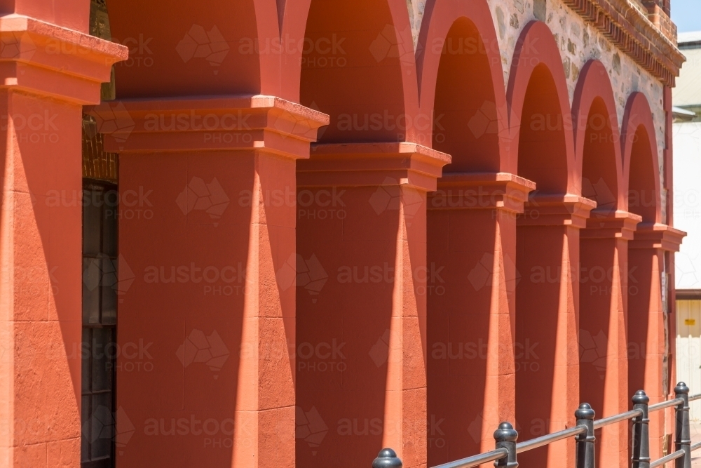 A row of brightly coloured arches in an historic building - Australian Stock Image
