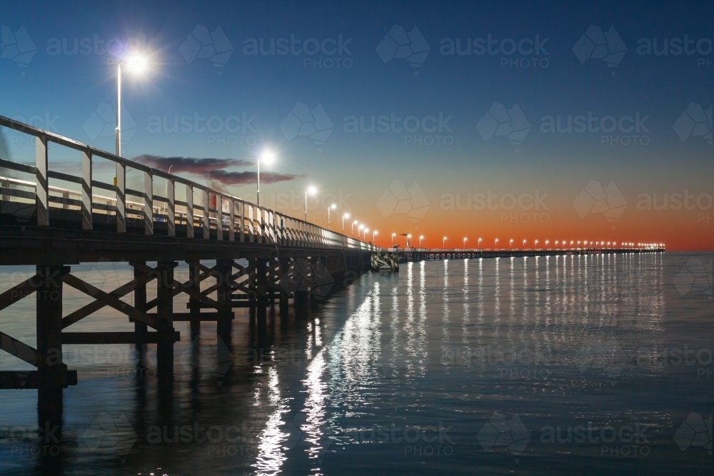 A row of lights out to the end of the Busselton Jetty at twilight - Australian Stock Image