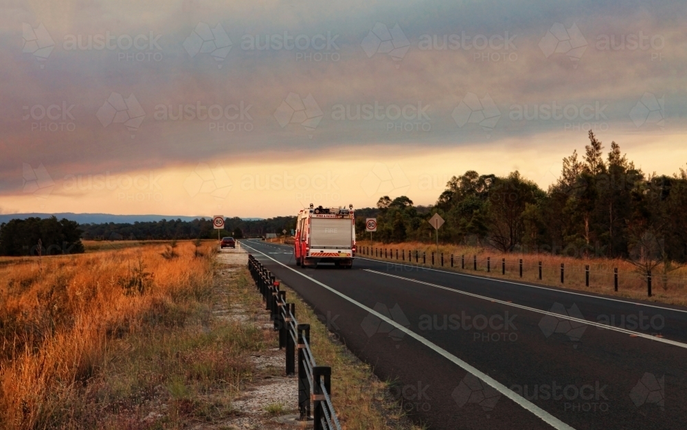 A  Rural Fire Service, fire and rescue vehicle responds urgently to a large out of control bushfire - Australian Stock Image