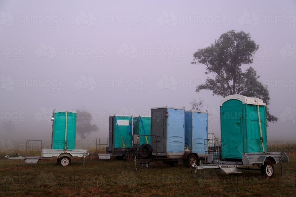 A series of portaloos on trailers in the country. - Australian Stock Image