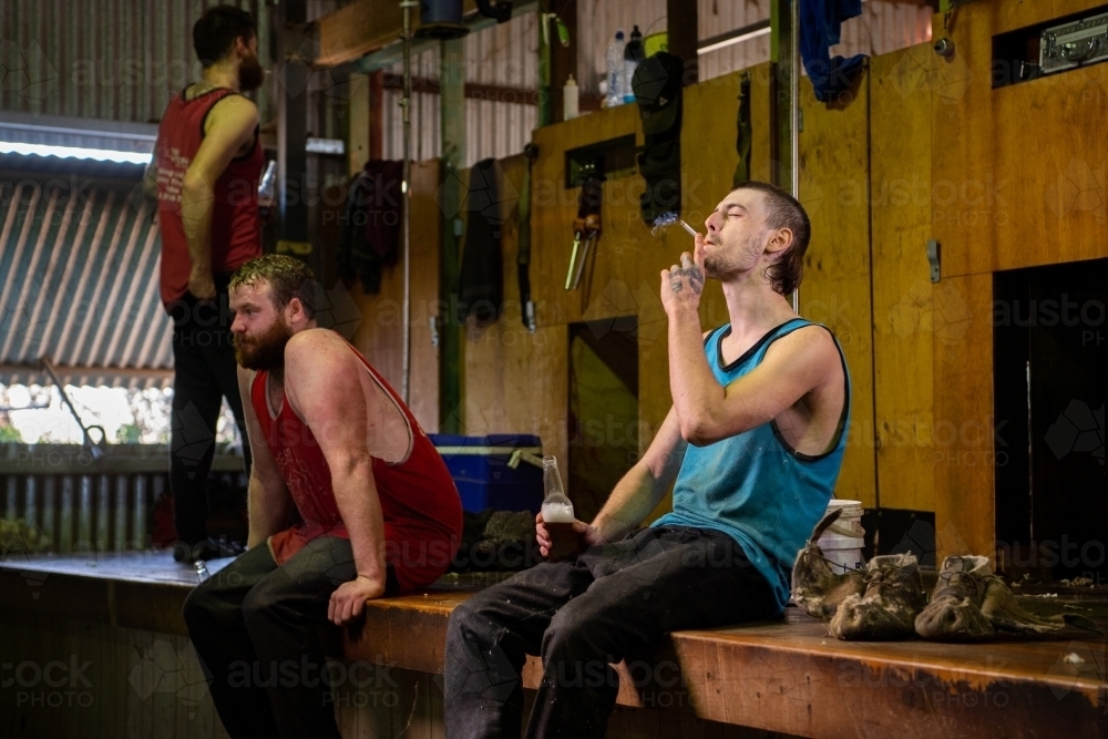 A shearer enjoys a cigarette and beer after work - Australian Stock Image