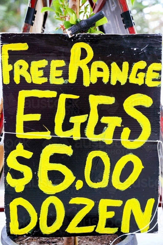 A sign advertises free range eggs for sale - Australian Stock Image