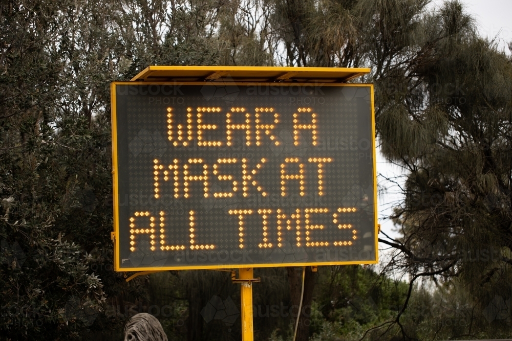 A sign during the COVID-19 corona virus pandemic which says 'wear a mask at all times' - Australian Stock Image