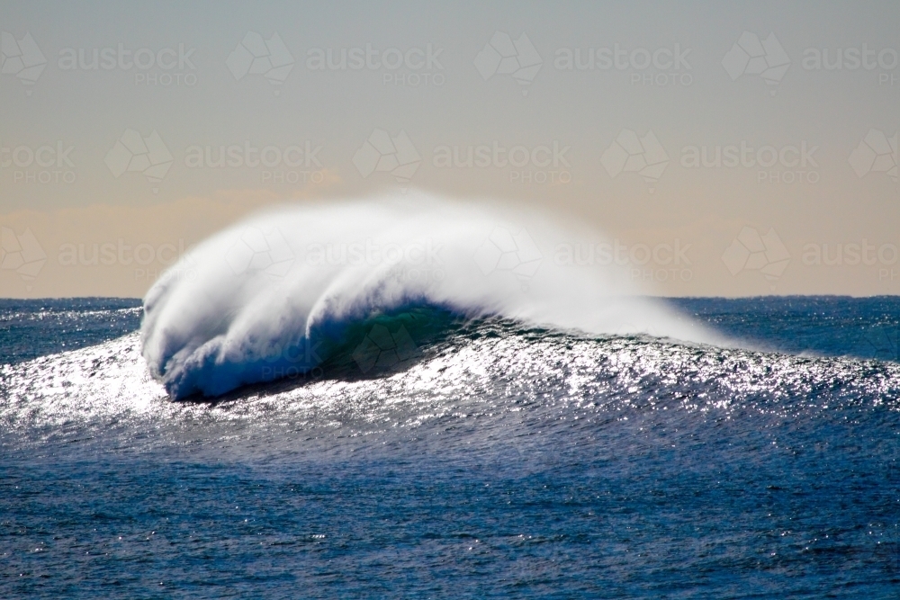 A single large wave rising with lots of sea spray at Bulli, NSW - Australian Stock Image