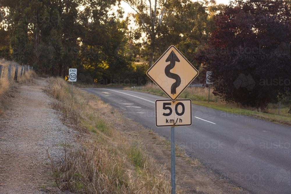A speed and windy road sign in a country setting - Australian Stock Image