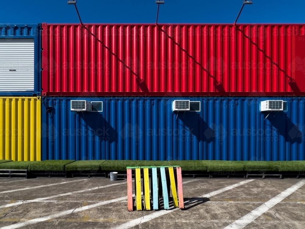 A stack of colourful shipping containers with air-conditioning units - Australian Stock Image