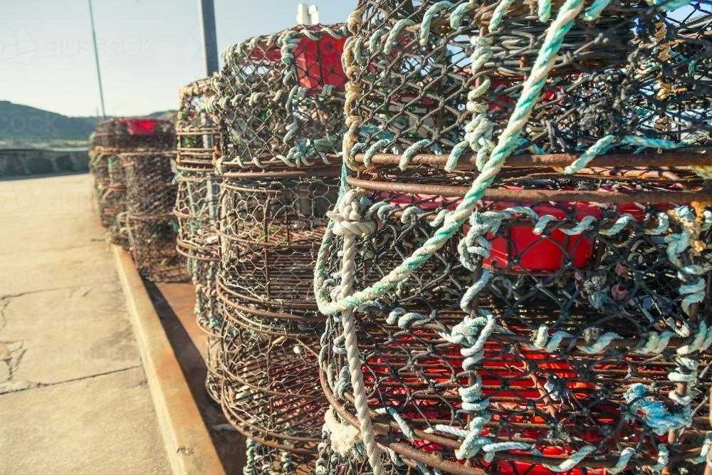 A stack of lobster pots on a jetty - Australian Stock Image
