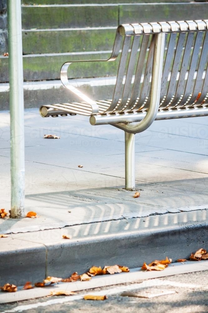 A stainless steel seat on the footpath - Australian Stock Image