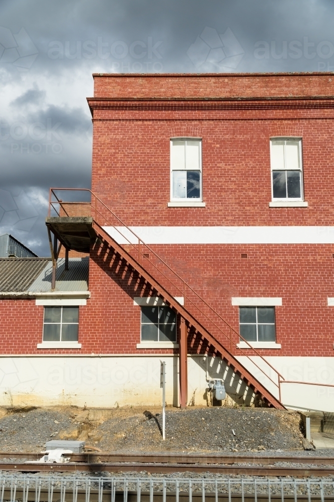 A staircase on the outside of a factory brick wall - Australian Stock Image