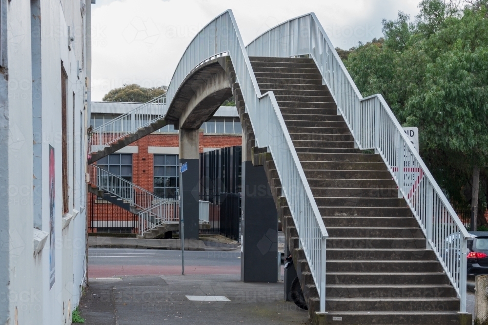 Image of A staircase with high railings leading up to a pedestrian ...
