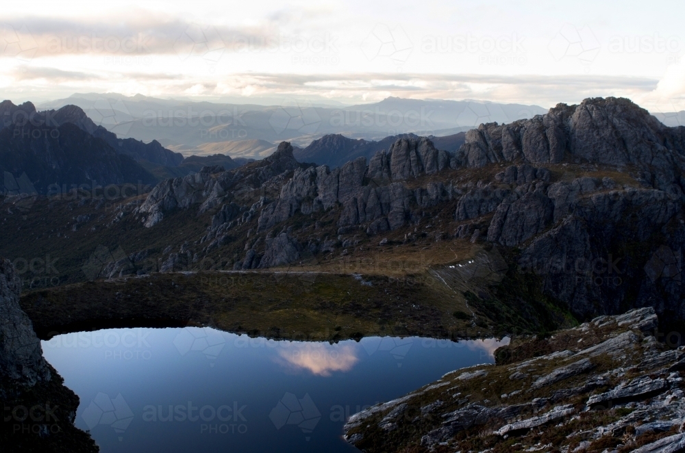 A still lake in front of a mountain range - Australian Stock Image