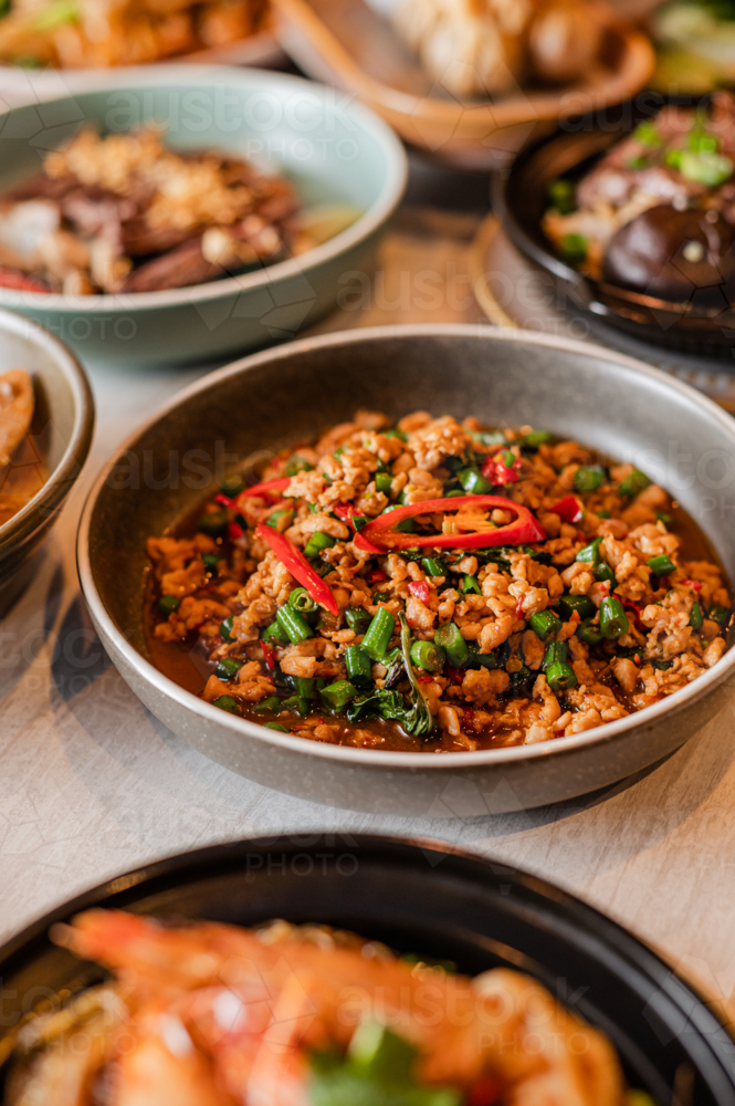 A stir-fried dish is presented in a bowl, showcasing minced meat mixed with vibrant vegetables - Australian Stock Image