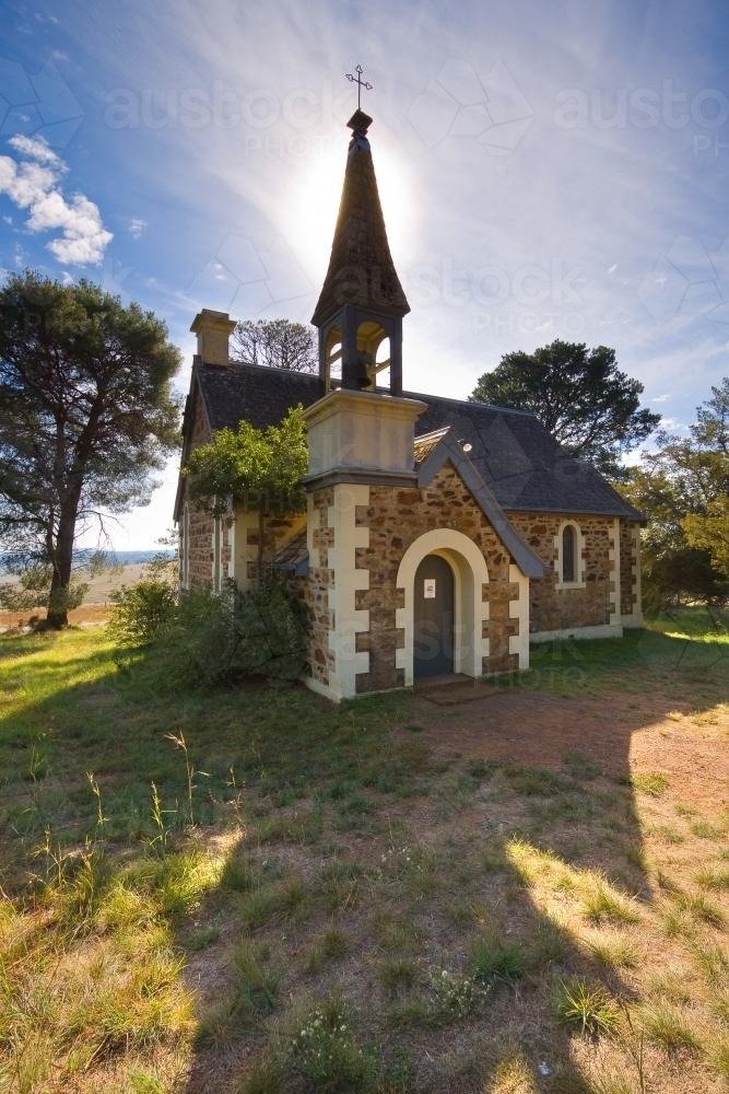 A stone church with a tall steeple - Australian Stock Image