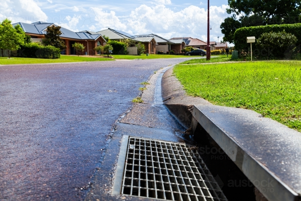 A Stormwater drain in gutter of suburban street - Australian Stock Image