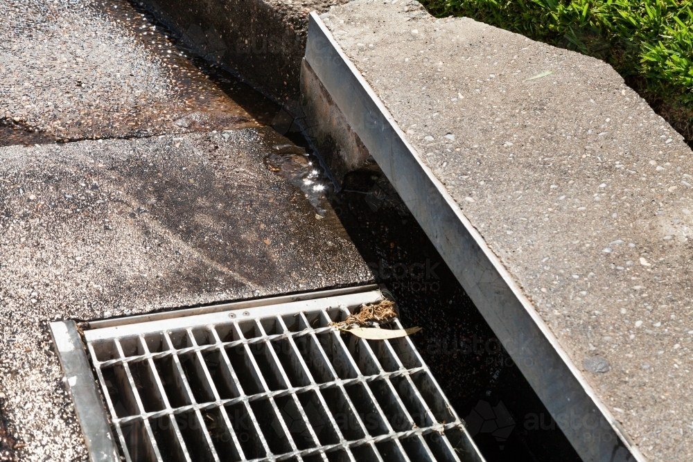 A Stormwater drain in gutter of suburban street - Australian Stock Image